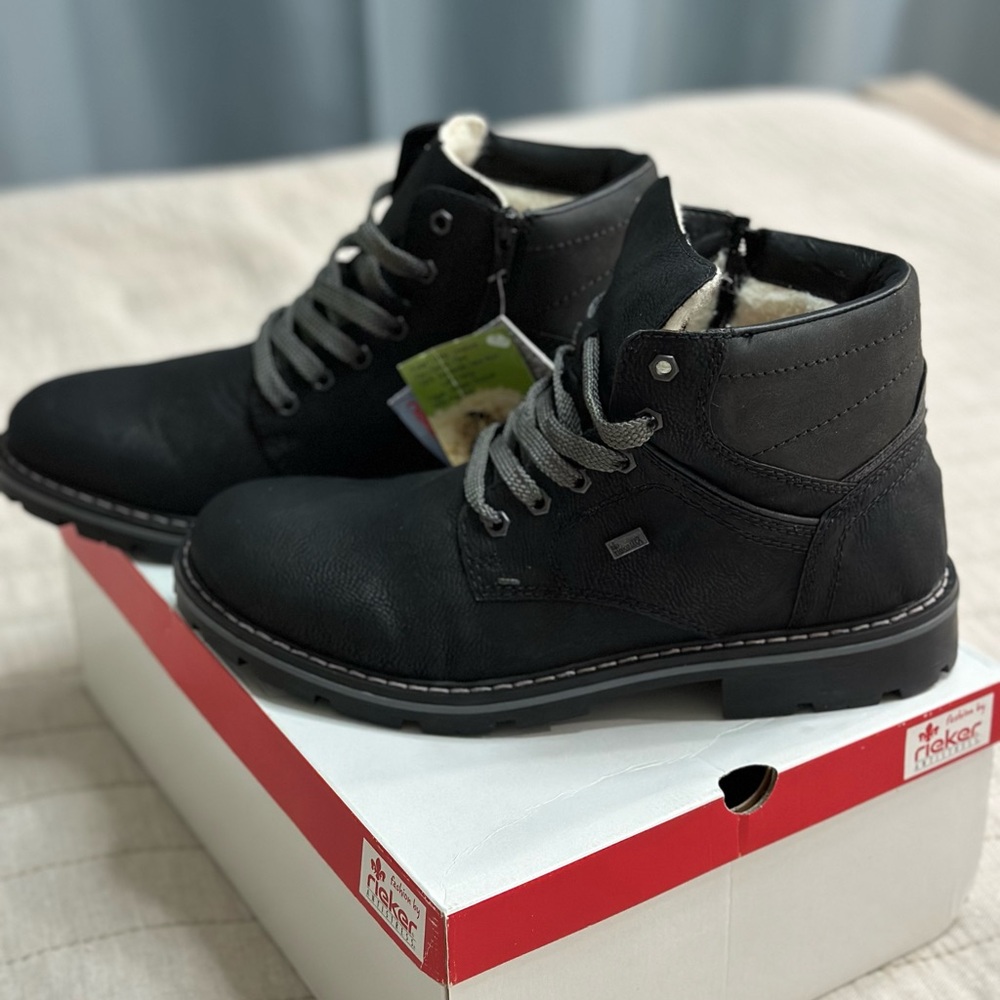 Rieker Men's Black Leather Ankle Boots with Wool Lining and Zip Closure.